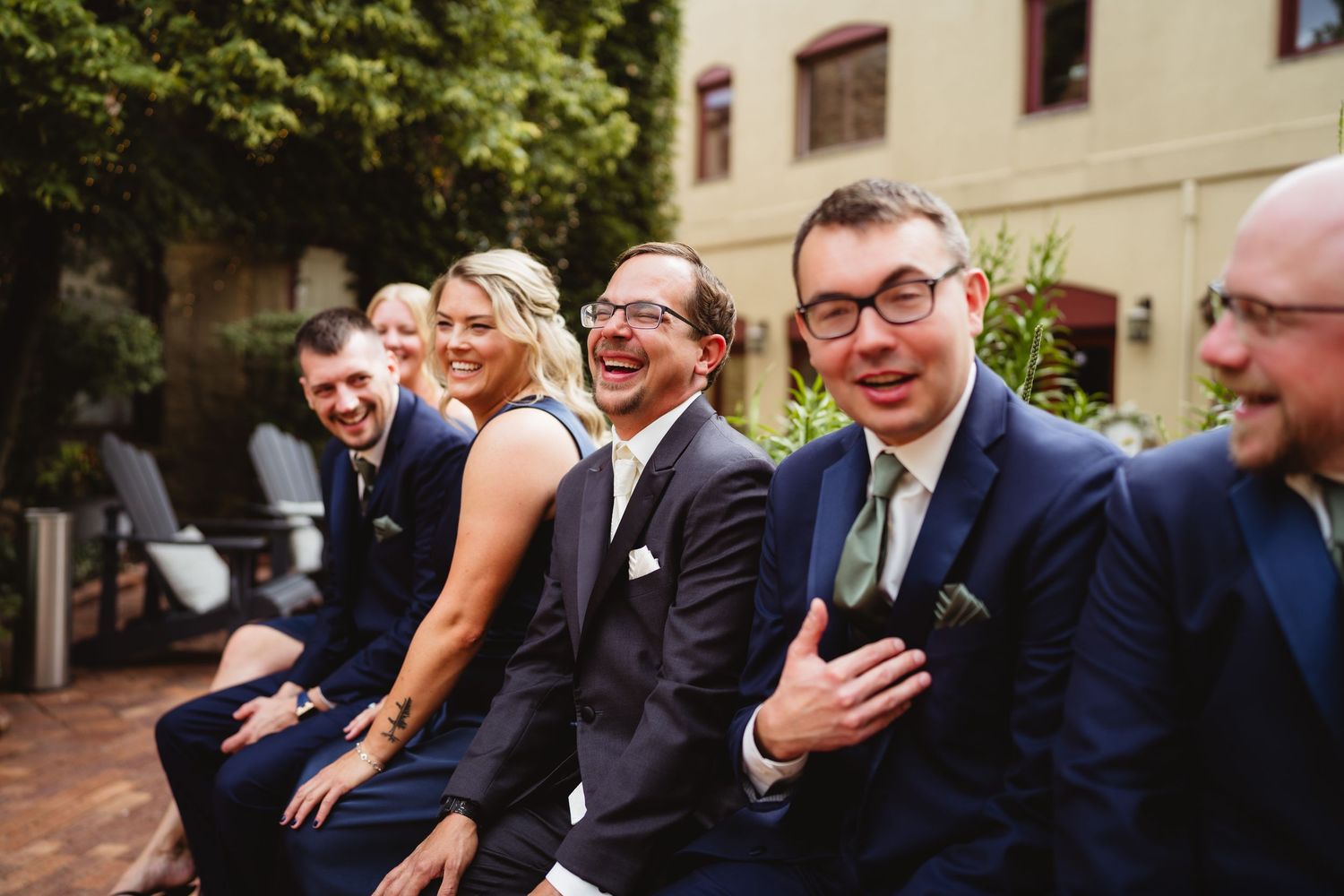 Wedding guests laughing and enjoying themselves during an outdoor reception.