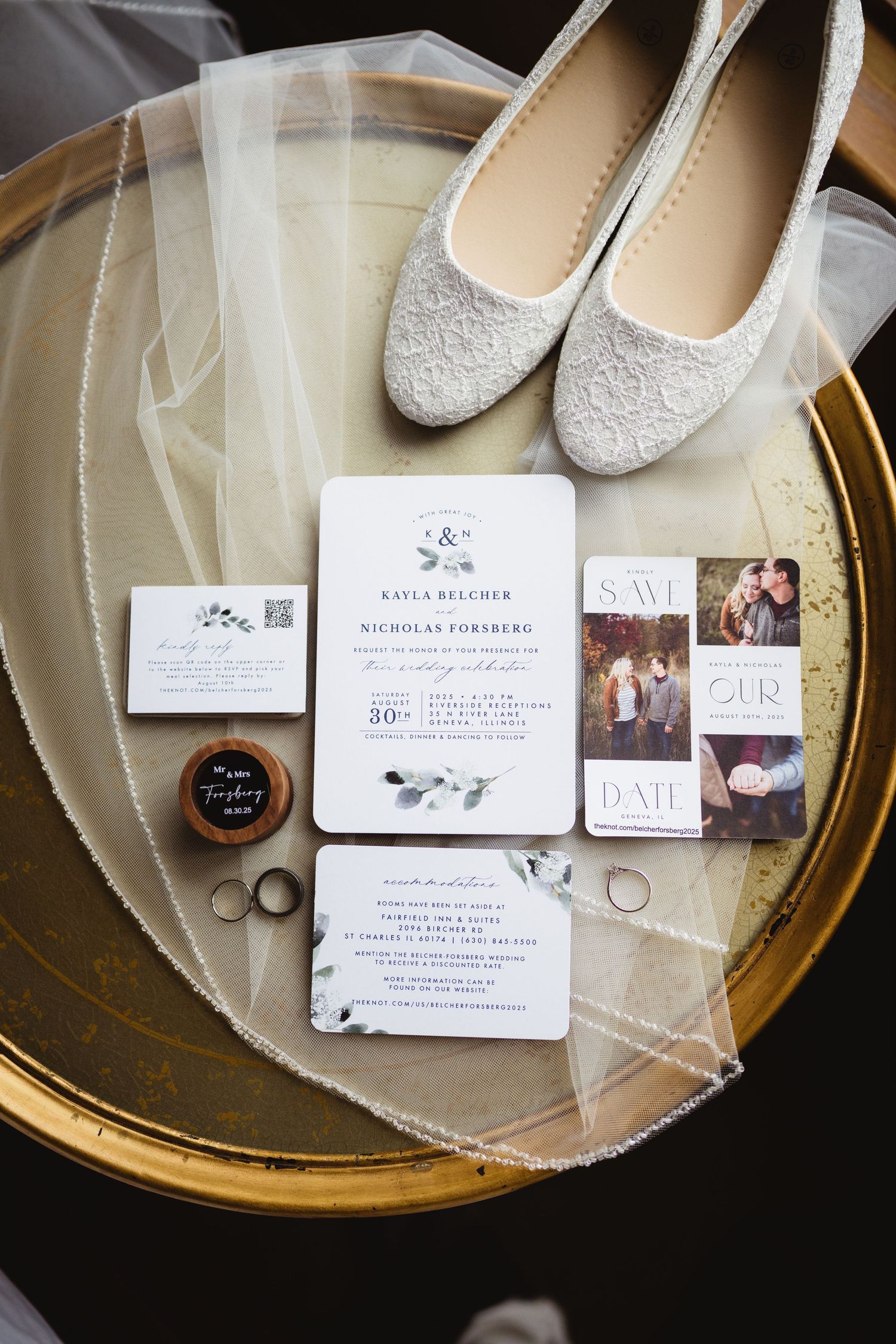 Wedding invitation cards and glittery shoes arranged on a gold-rimmed glass tray for detail photography.
