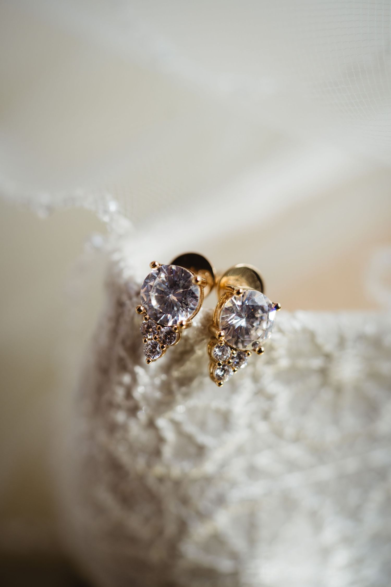 Close-up sequence showing a delicate golden ring with sparkling diamond details against a soft white textured background.
