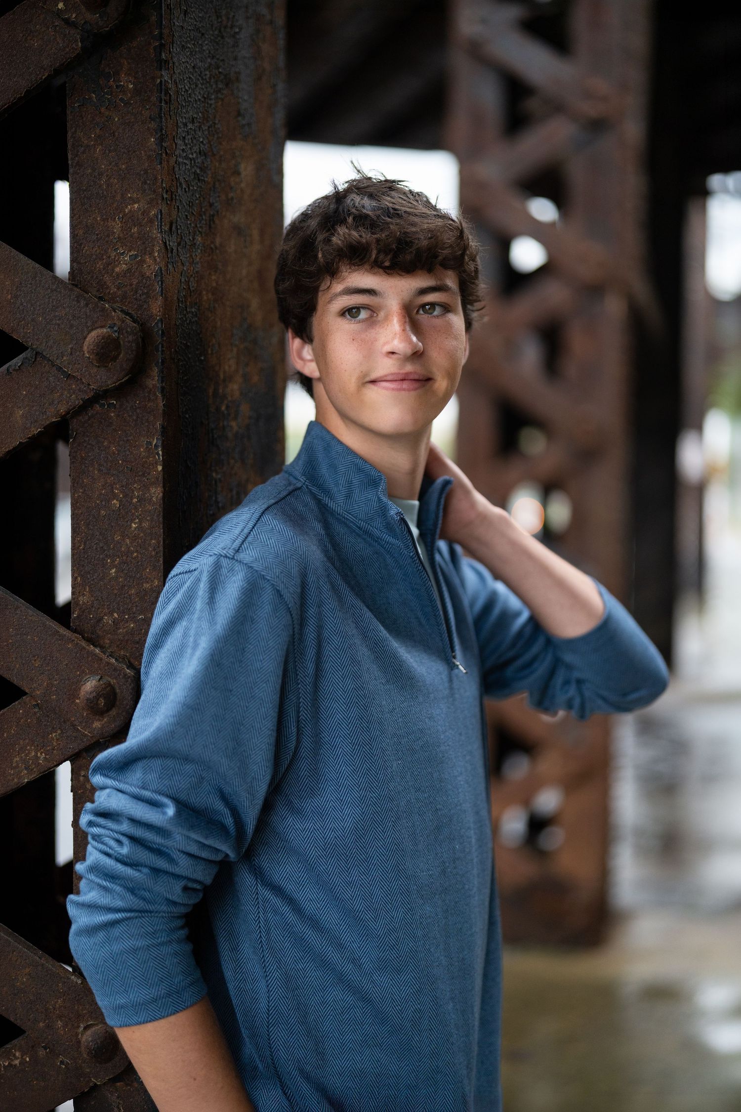 Senior leaning against large mural in downtown Westerville, Ohio for a senior photo session by Jamie Macey Photography