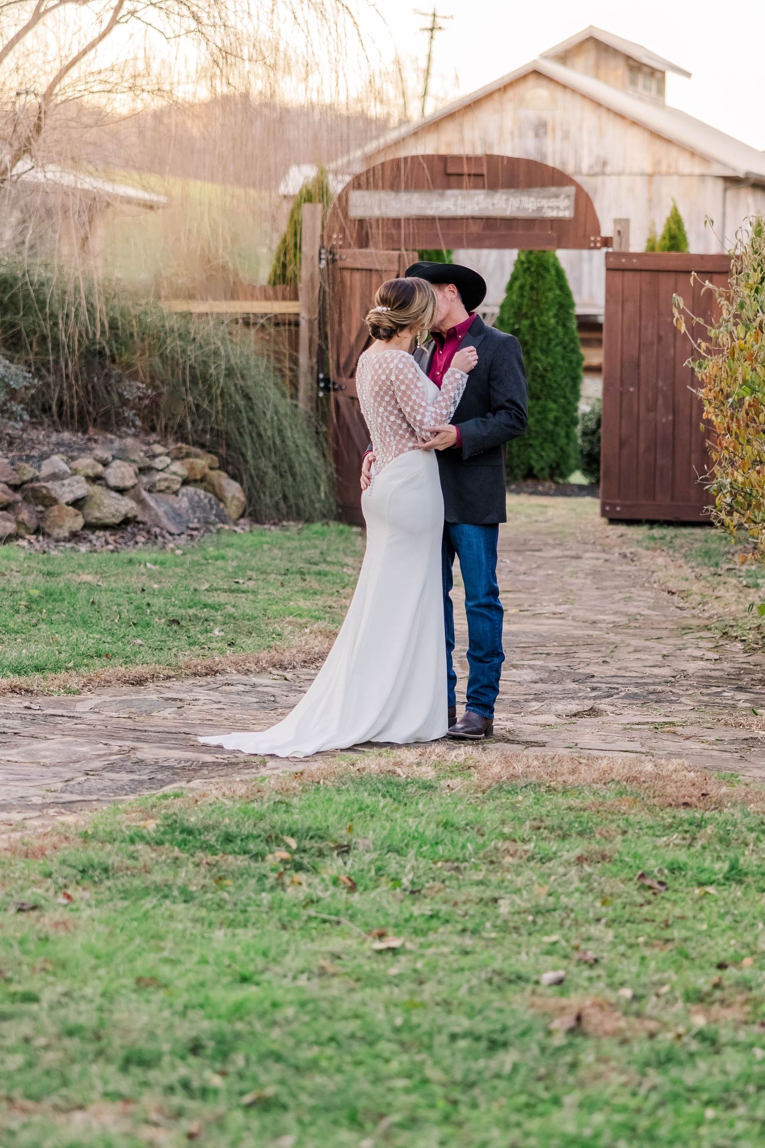 Intimate wedding moments captured outside a rustic barn setting at dusk.