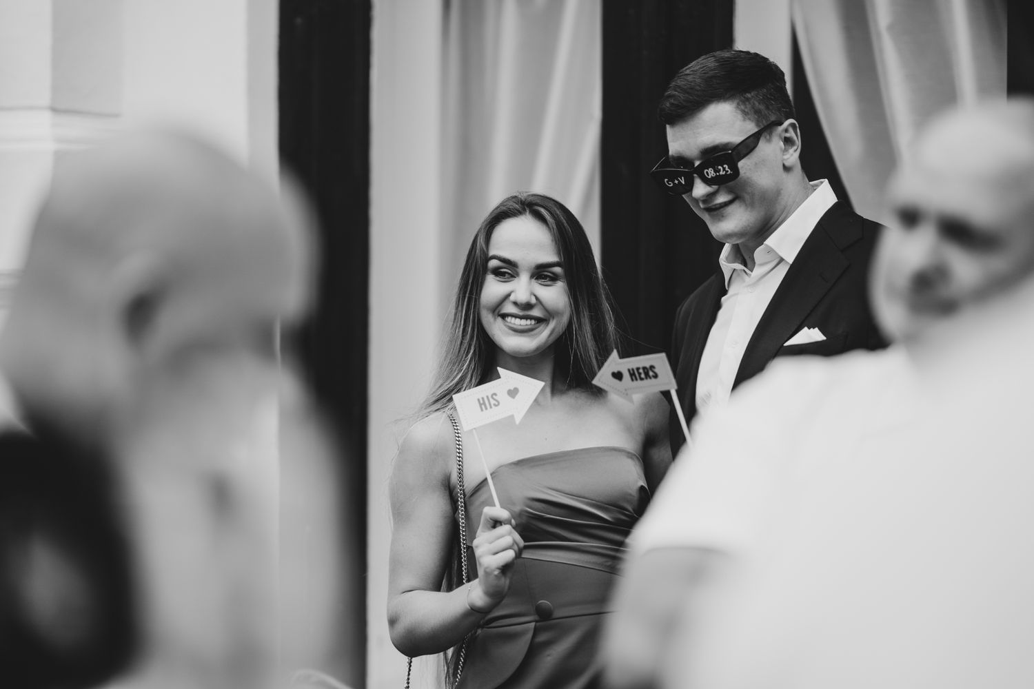 Elegant indoor wedding reception with guests in formal attire.