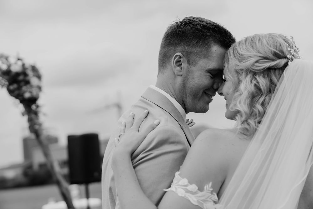 Black and white intimate wedding portrait outdoors.