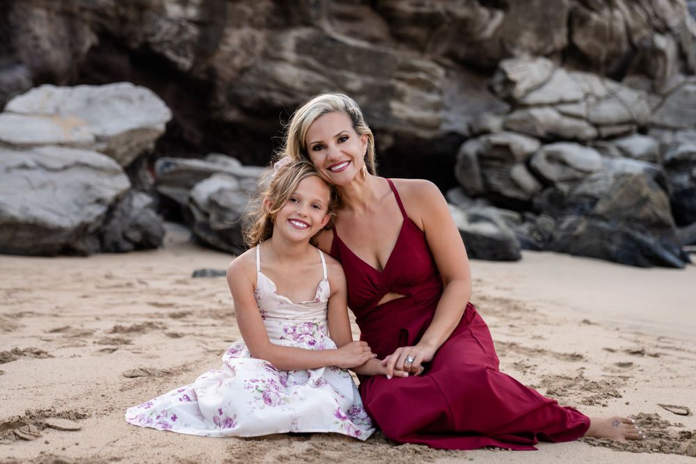Beautiful beachside portrait against rocky backdrop with warm evening light.