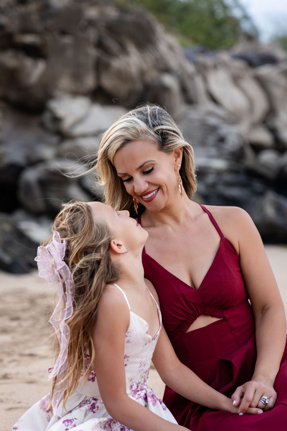 Intimate beachside moment captured against dramatic volcanic rock formations.