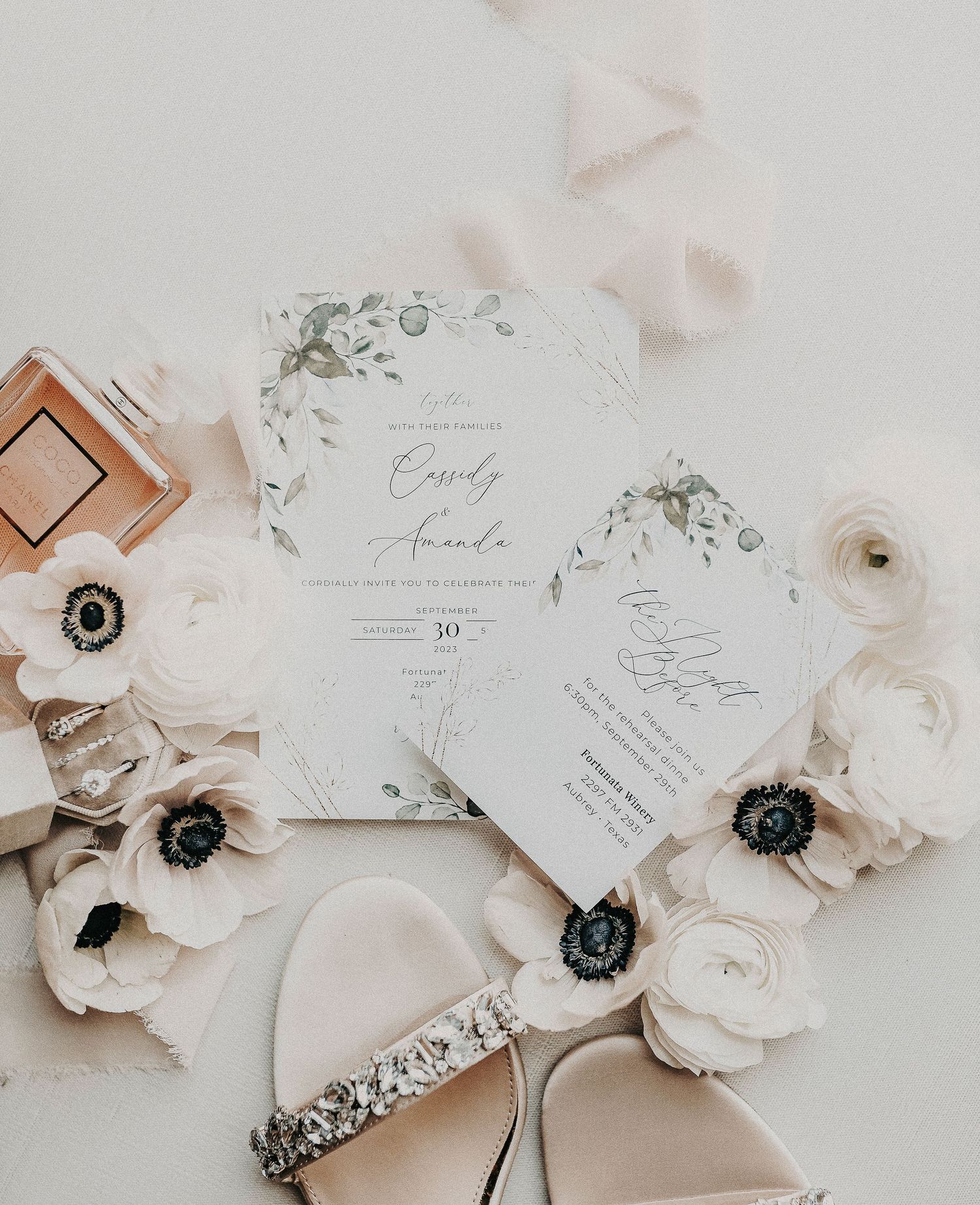 editorial bridal details flat lay with vow books, perfume, and heirloom jewelry in soft natural light