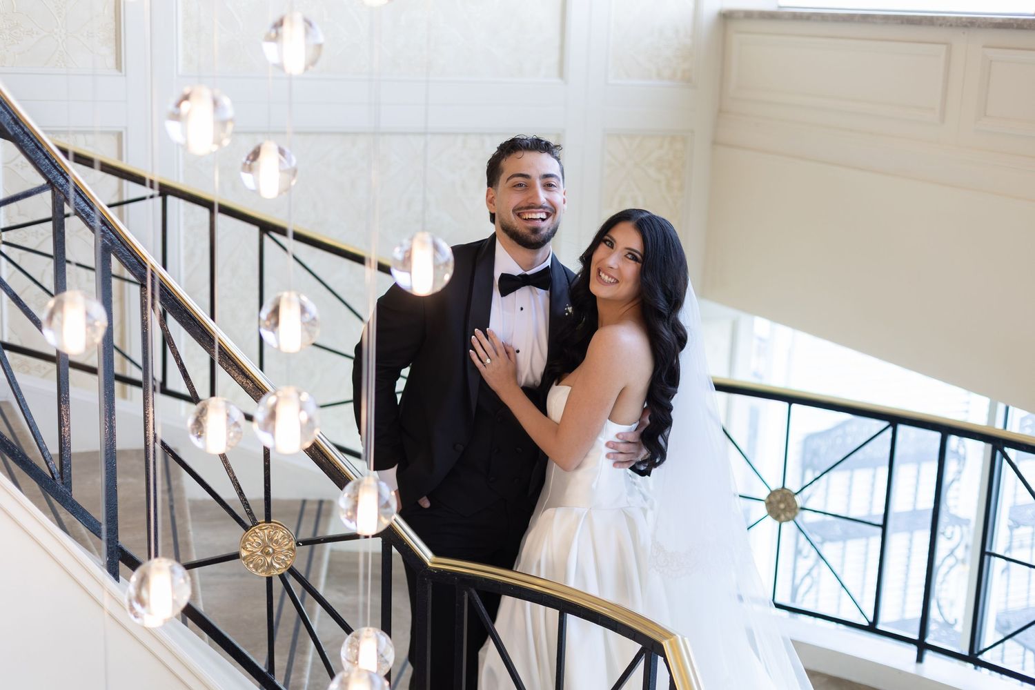 Bride and groom smiling together during portraits at Glen Island Harbour Club wedding venue.