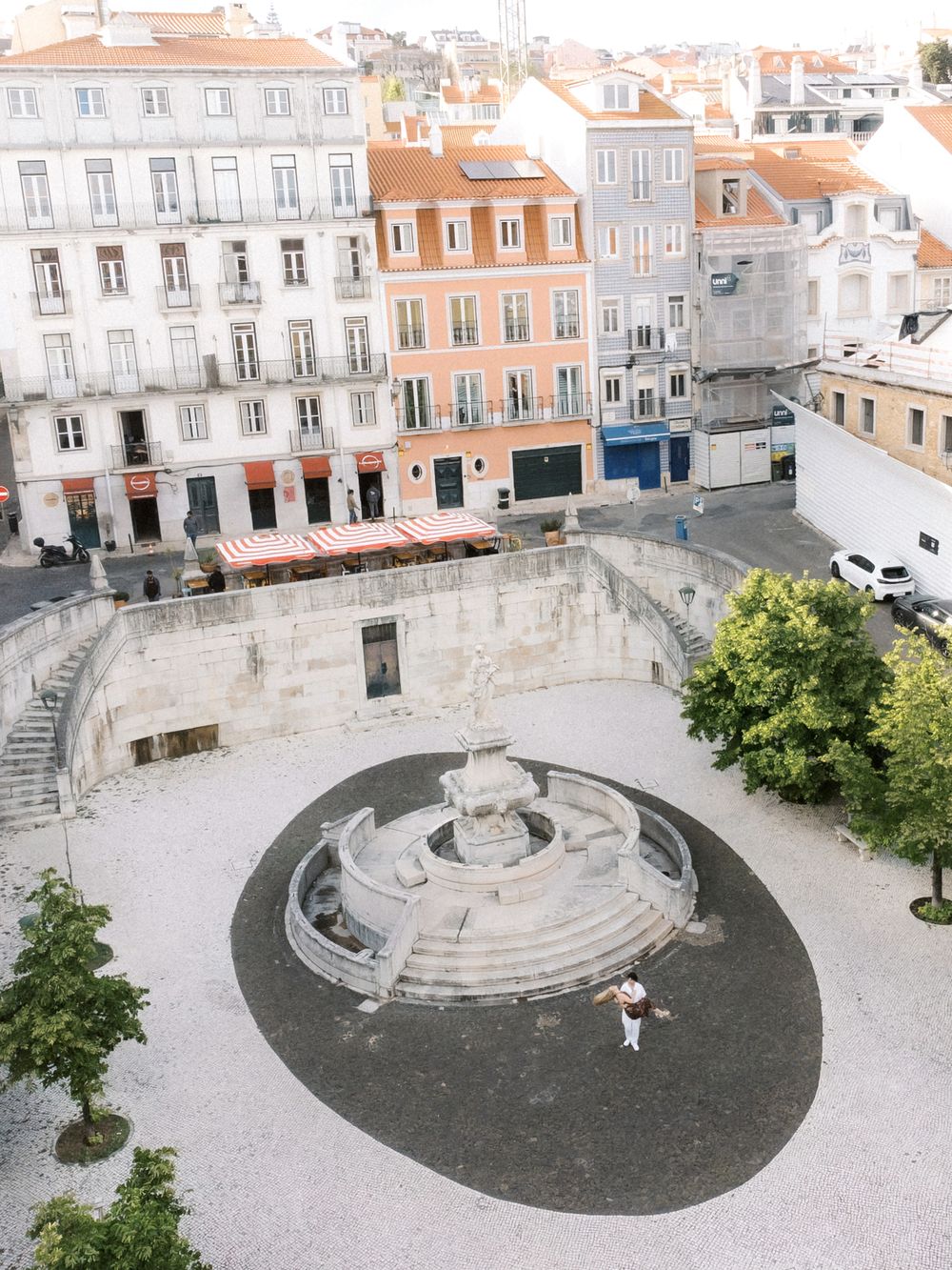 Couple embracing during a romantic Lisbon city session before their Portugal wedding