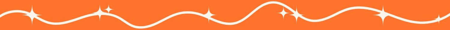 Rustic wooden lodge with colorful flower garden in foreground among tall pine trees.