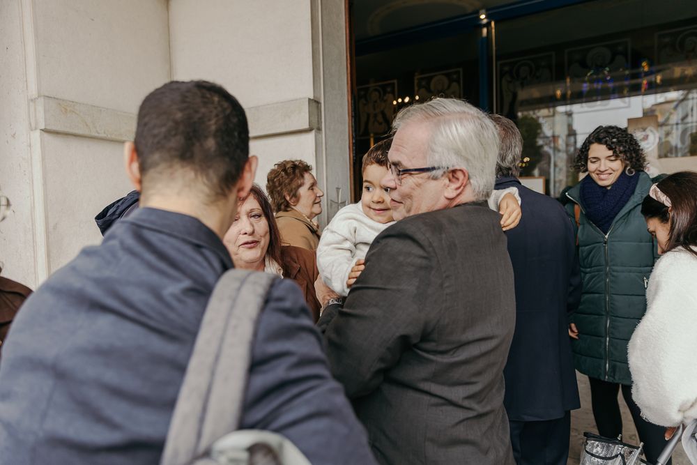 Group of people greeting and hugging at an outdoor social event.