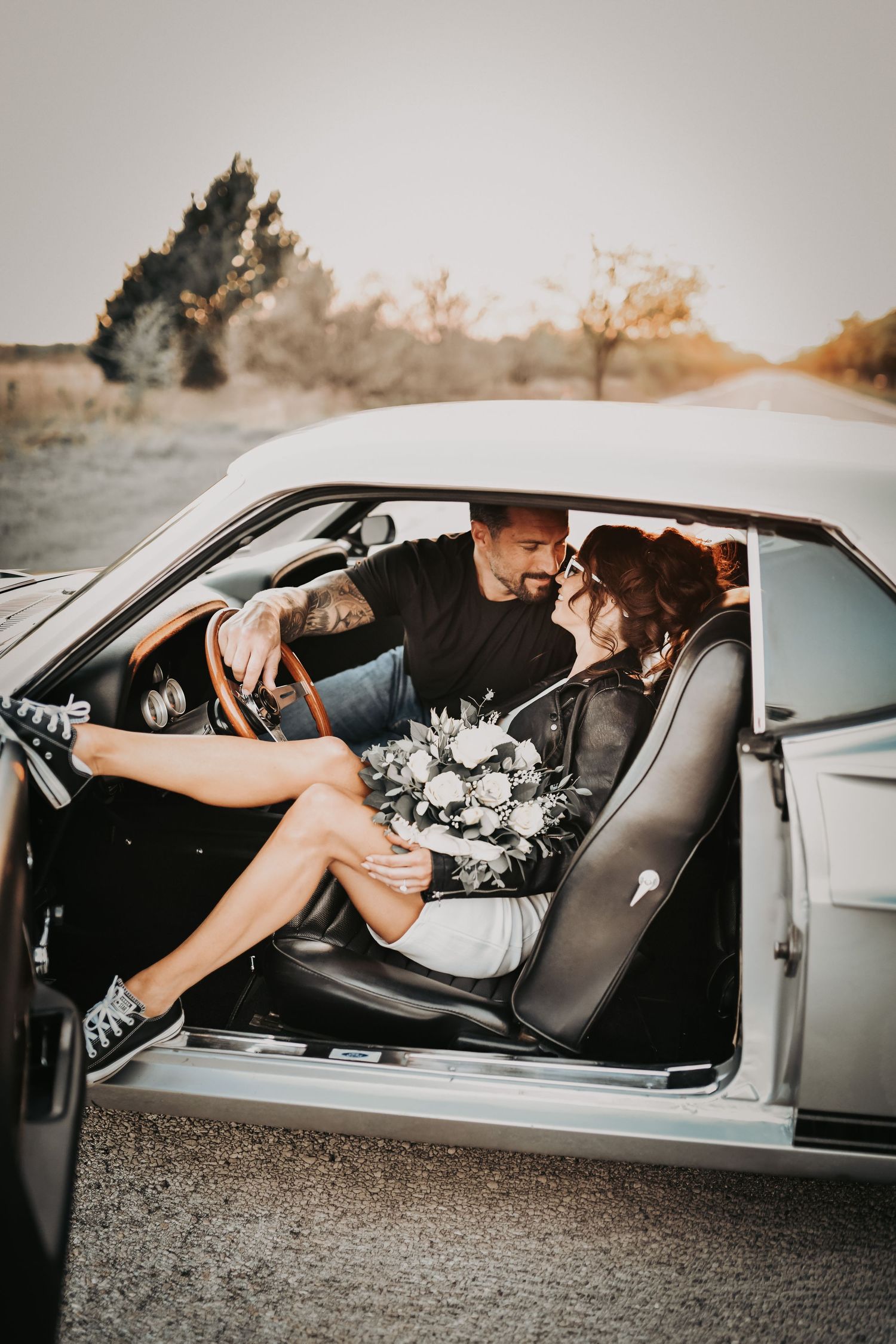 bride in vintage white dress with oversized bow and sneakers engagement session