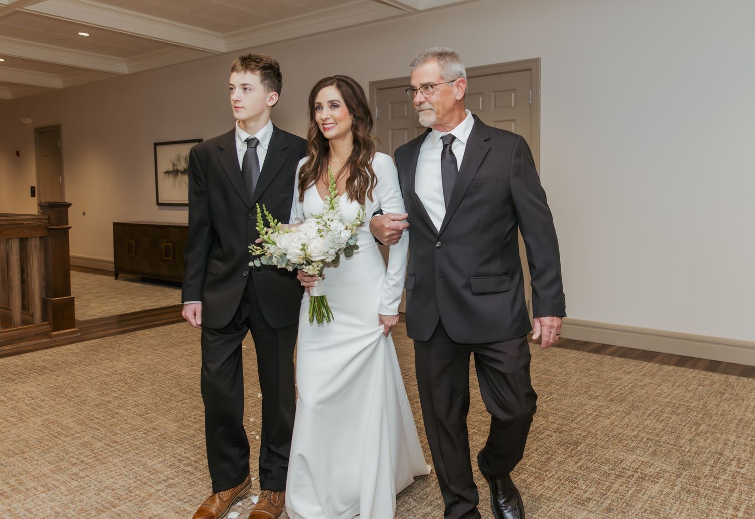 Bride walking down the aisle on her wedding day at Holliday Farms in Zionsville, Indiana