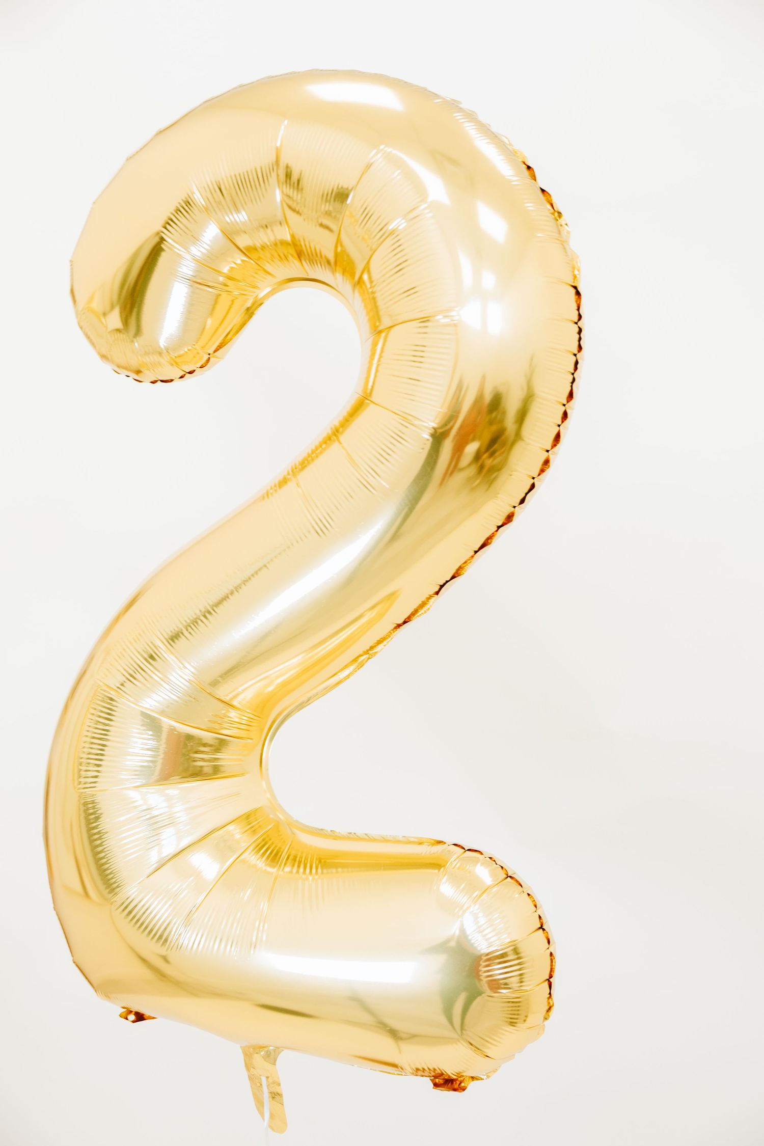 Large gold metallic number 2 balloon against white background.