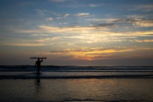 Surfer heading out to catch some waves in St. Augustine