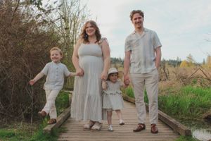 Portrait of a young family walking towards camera.