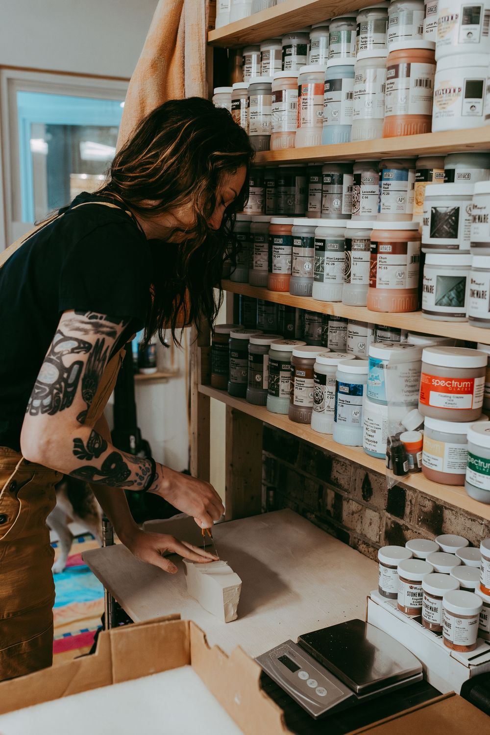 Woman cutting clay for pottery. Whitney Popp. Arizona photographer.