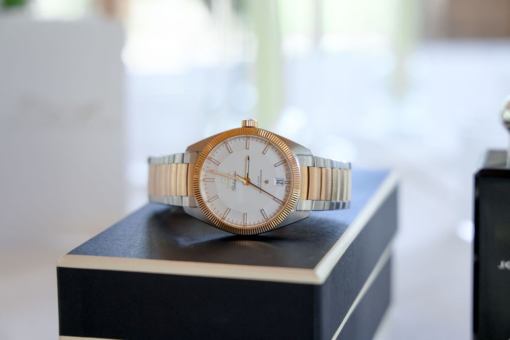 Gold watch displayed on black surface in elegant wedding day detail shot.