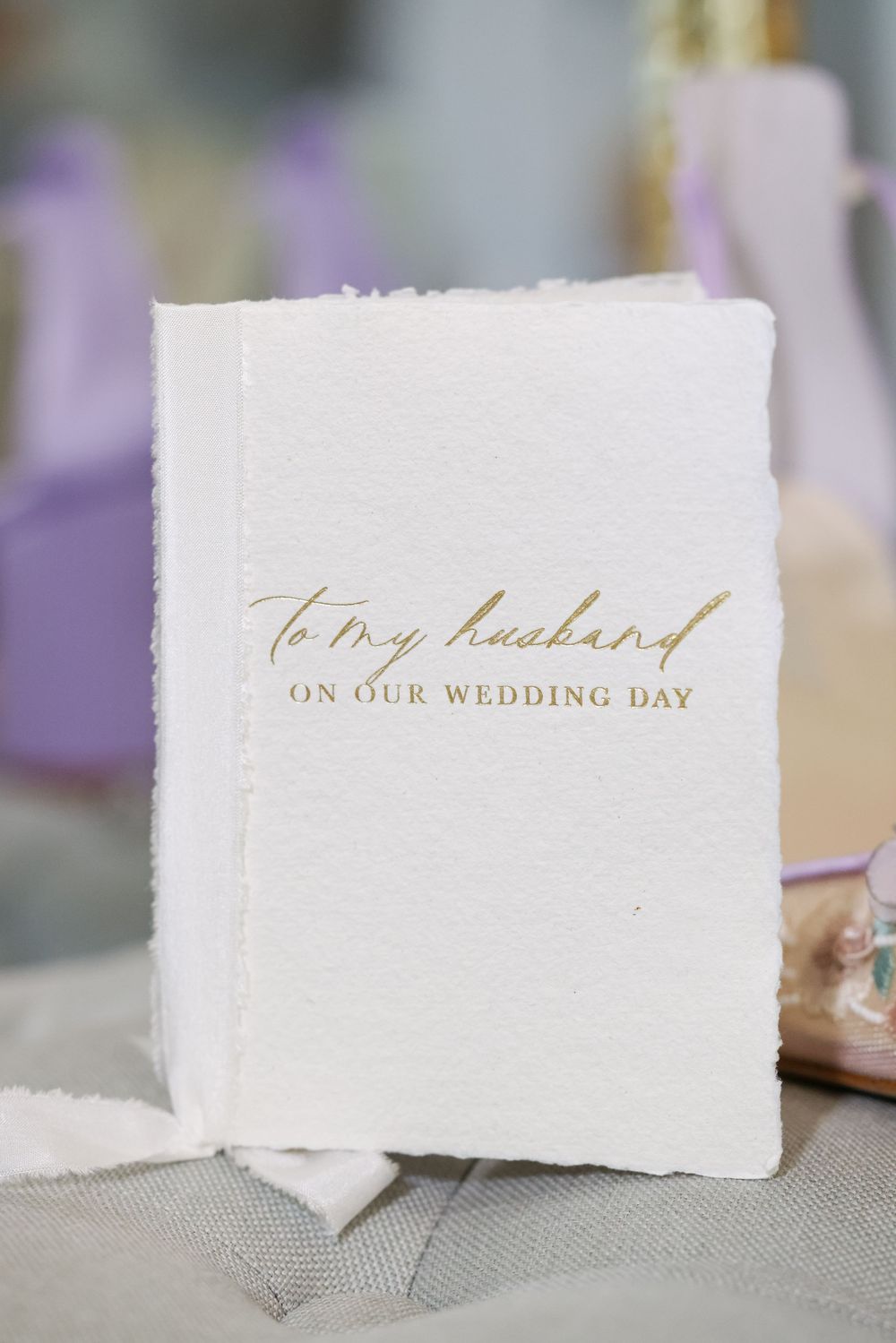 Elegant wedding day cards with gold calligraphy text on textured white paper.
