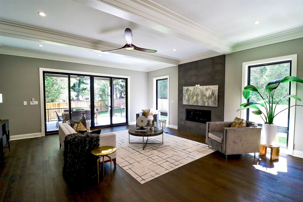 Modern open concept living room with white walls, hardwood floors and contemporary furnishings.