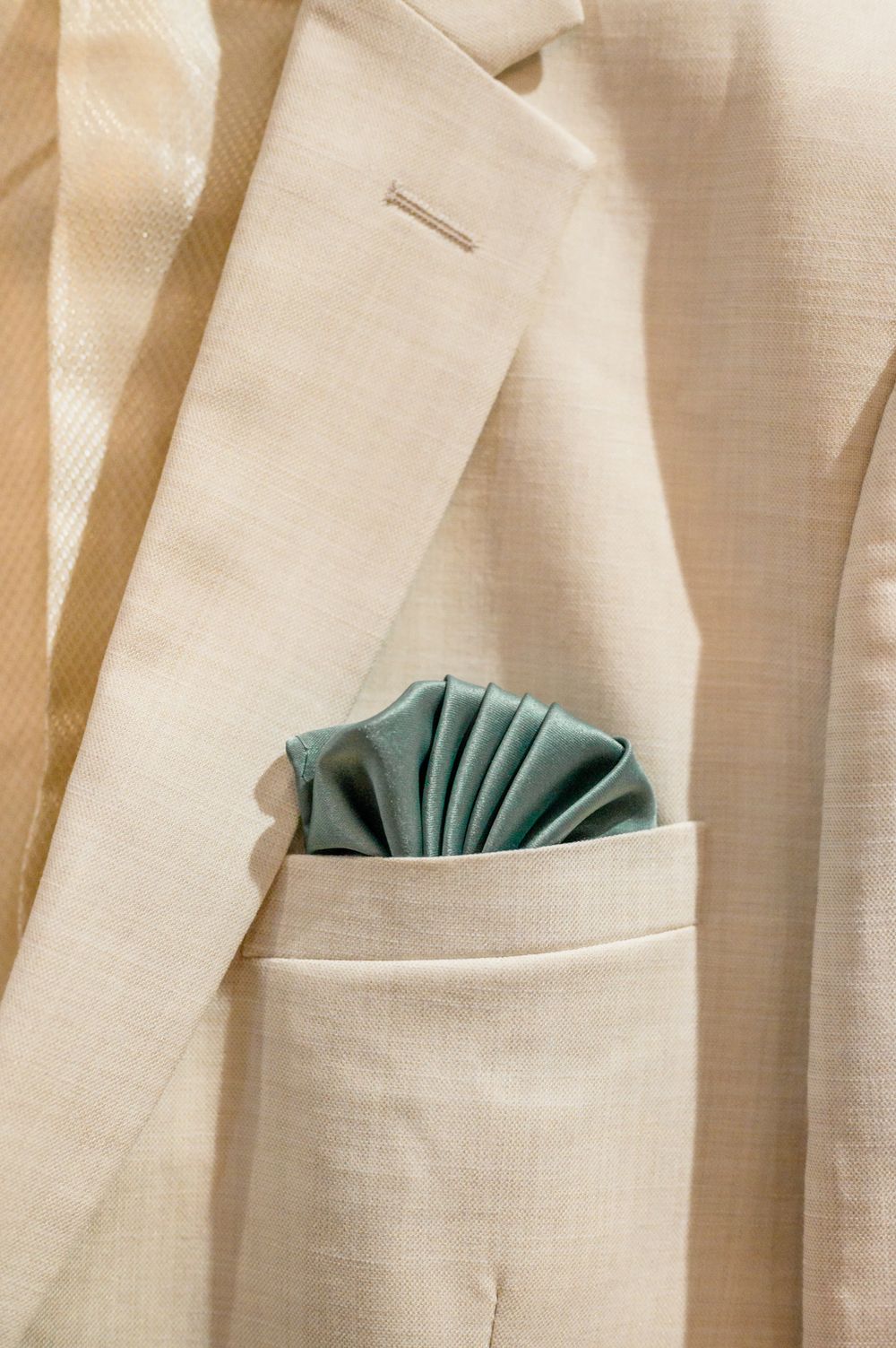 Cream colored curtain panels with sage green pocket square accents creating a pleated texture.