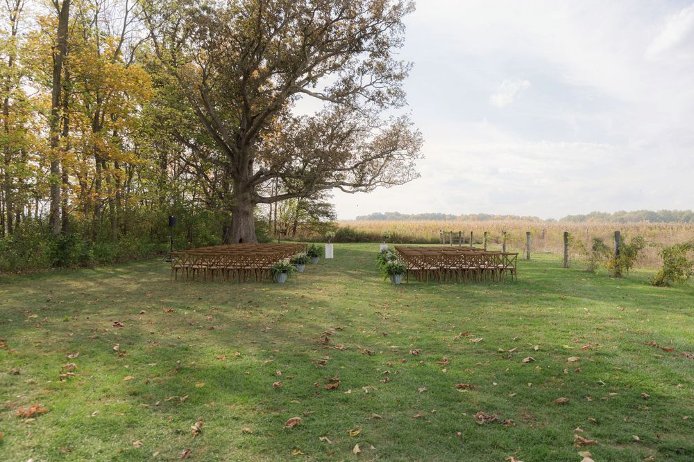 Aspen and Alston wedding ceremony overlooking fields in Ostrander Ohio fall wedding