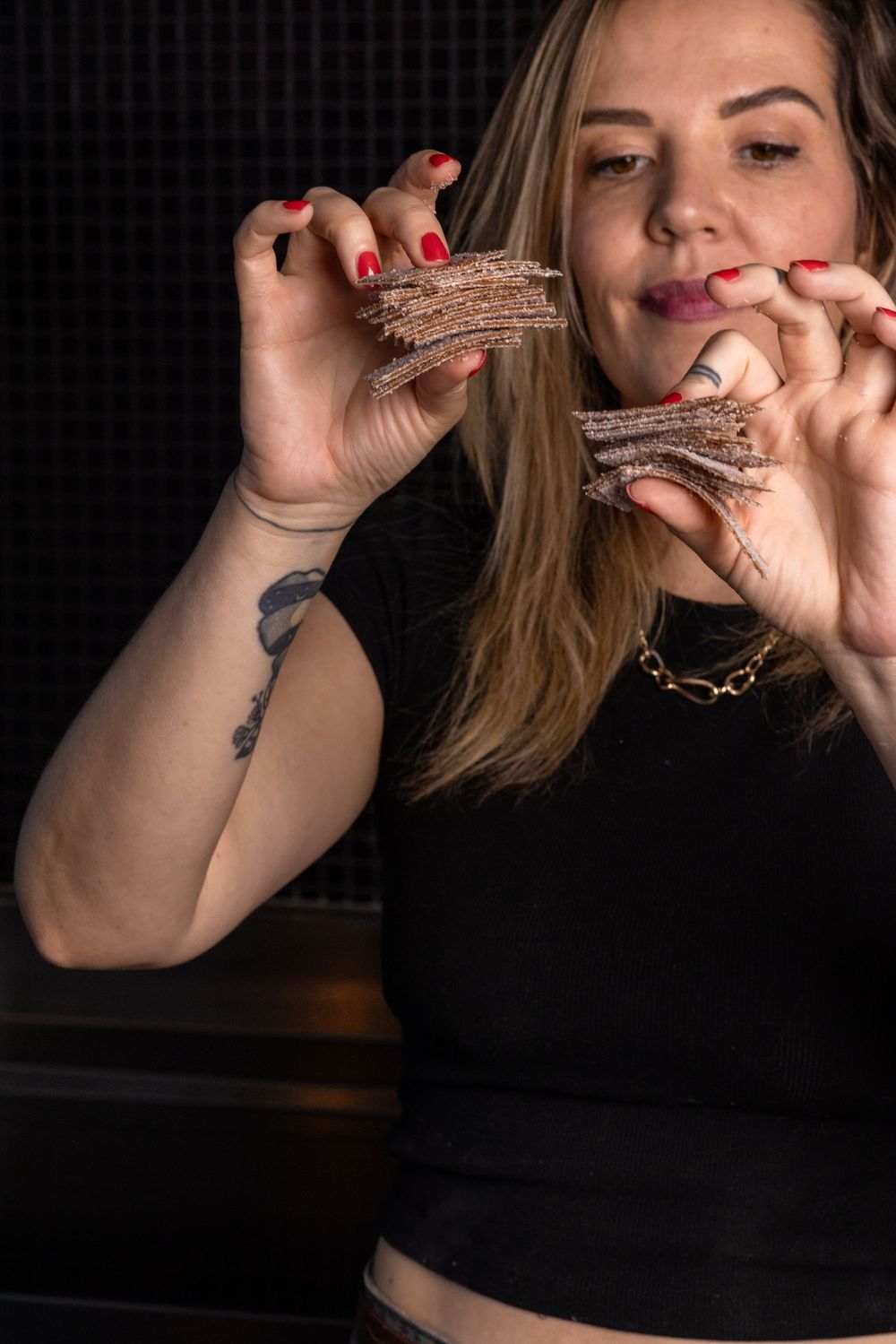 A series of close-up shots showing hands holding and smoking a cigar against a dark background.