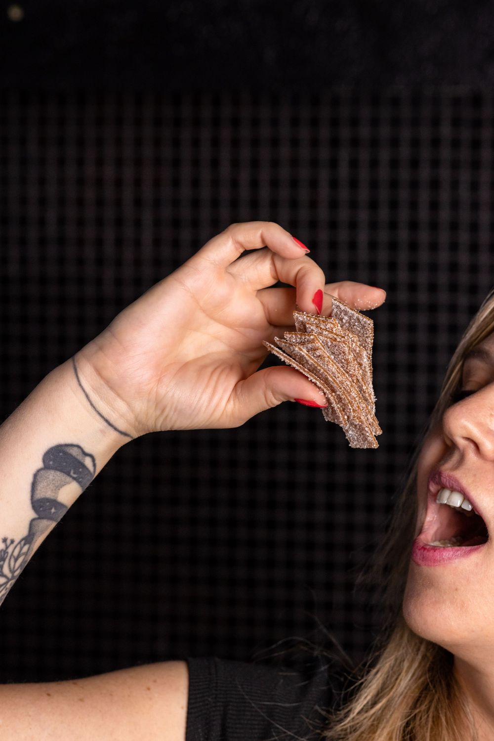 A sequence of photos showing a hand bringing a piece of toast to someone's mouth against a dark background.