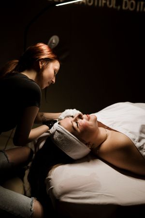 A sequence of dark, atmospheric photographs capturing a relaxing spa treatment with dramatic lighting and shadows.