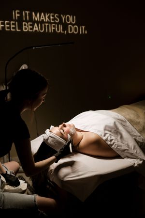 A series of moody boudoir photos showing silhouetted figures reclining on white bedding in dramatic lighting.