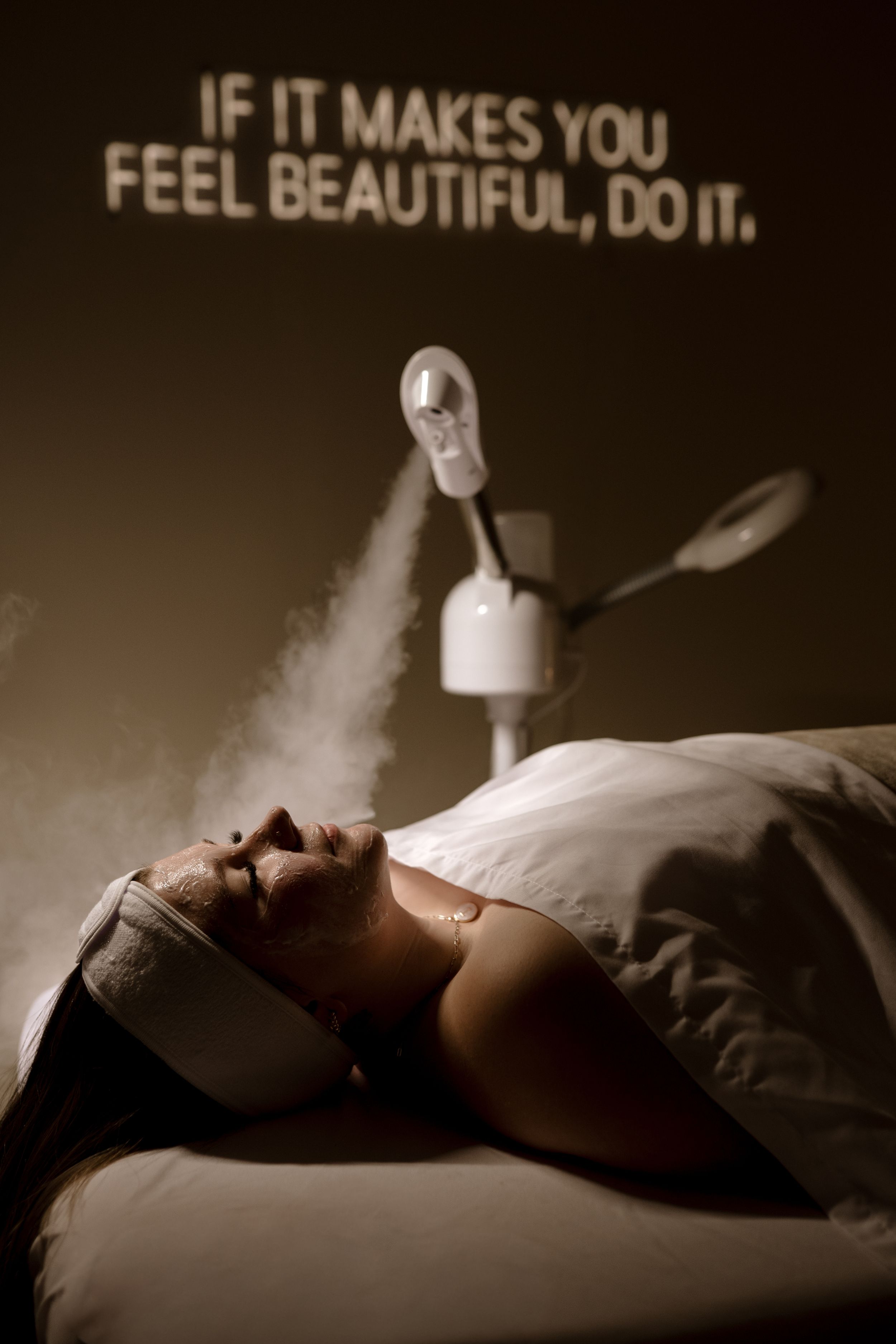 Black and white photo series showing a person lying in bed with text reading 'If it makes you feel beautiful, do it'.