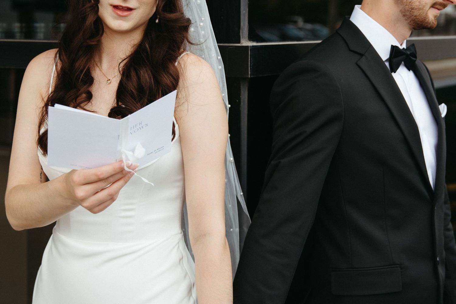 bride and groom hold hands during private vows, intimate first look at CANVAS hotel, Moncton wedding photography timeless photos elegant