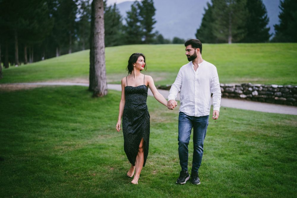 Stylish couple taking a romantic stroll through a scenic golf course.