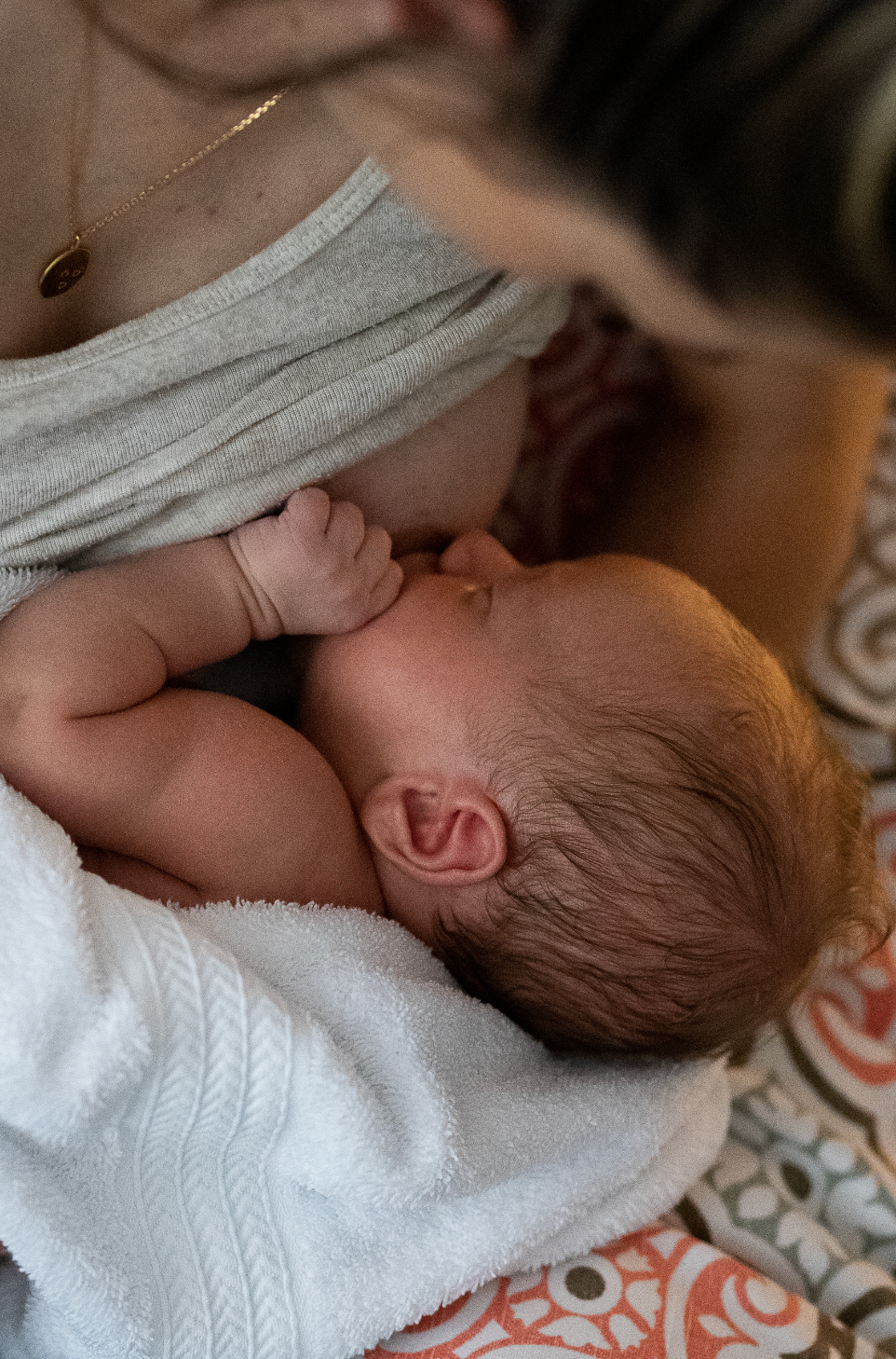 Close-up image of a newborn baby wrapped in a white blanket.