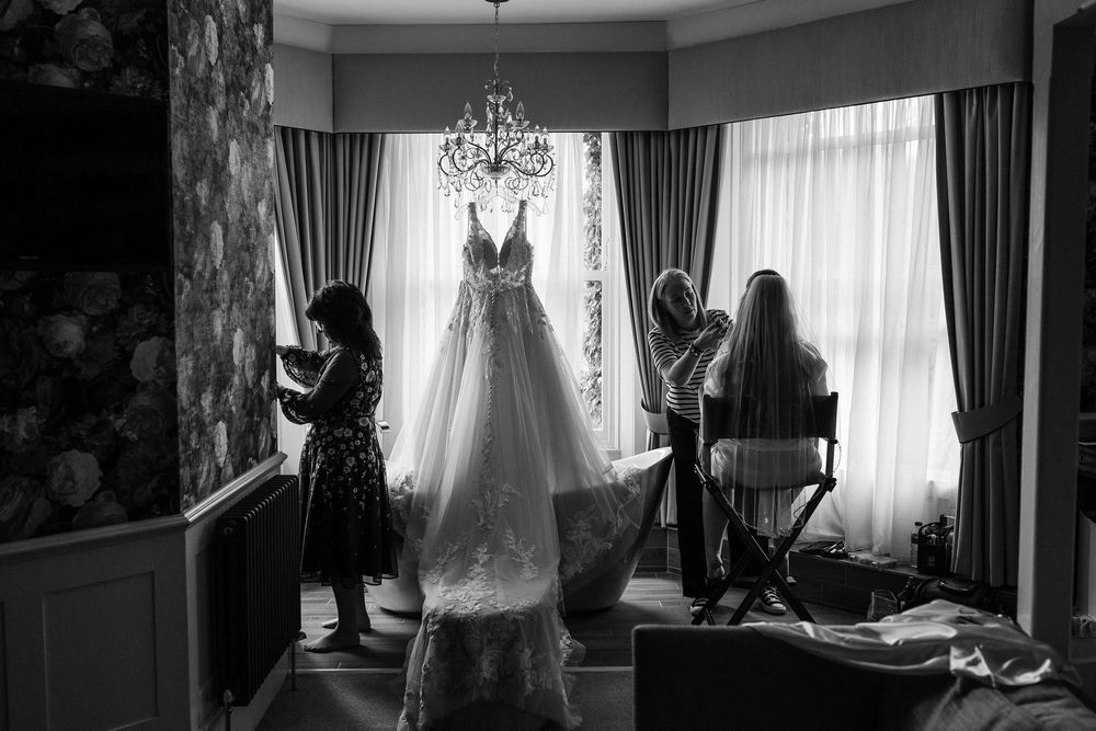 A dramatic black and white photo series showing interior scenes with curtains and furniture in moody lighting.