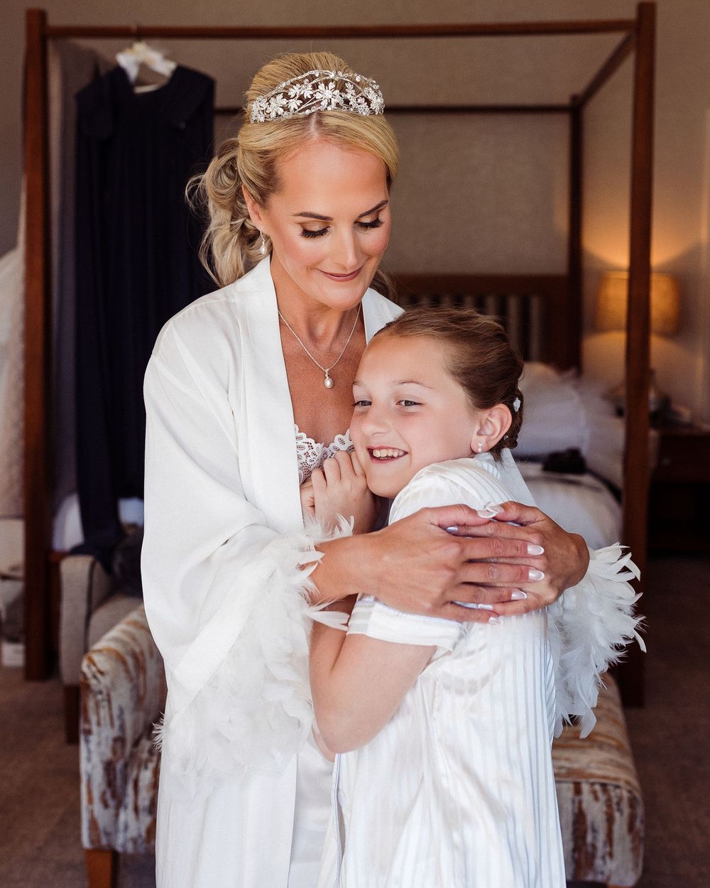 A series of tender moments captured between two people in white robes during wedding preparations.
