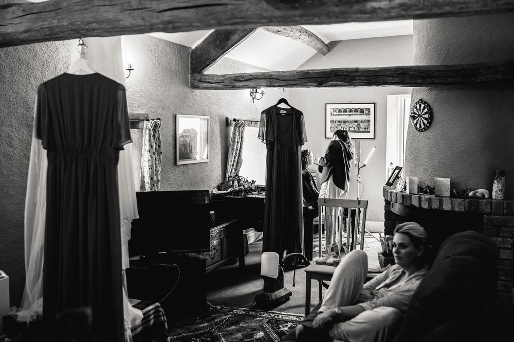 A series of black and white photographs showing dark silhouettes and shadows in interior spaces with dramatic lighting.