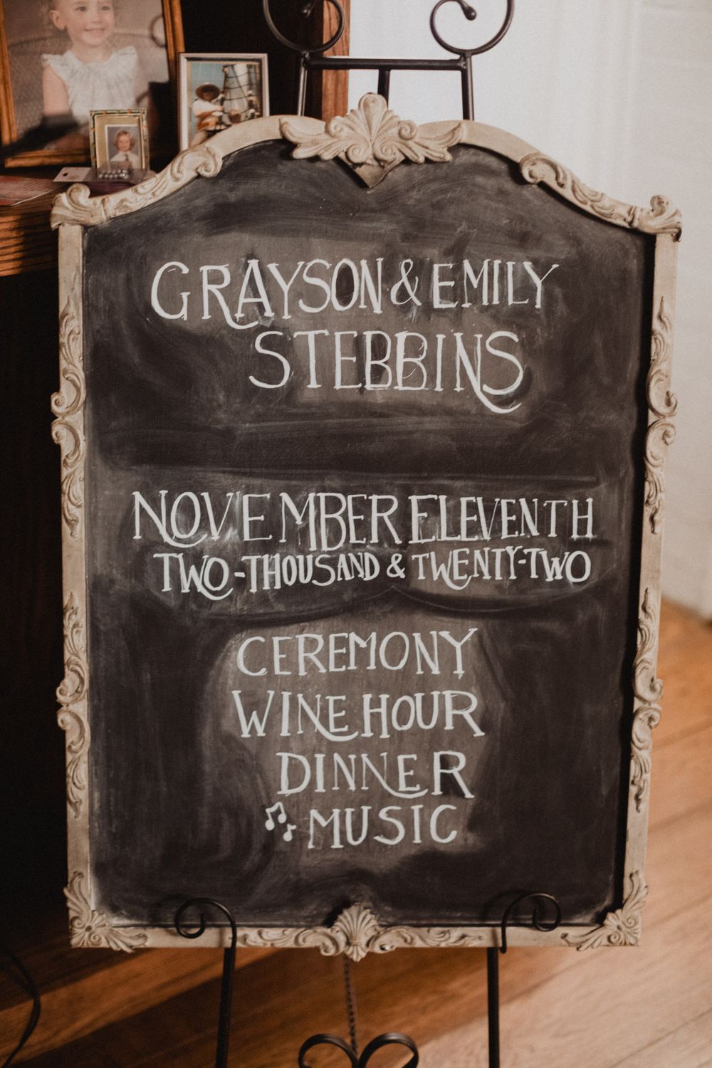 Vintage-style chalkboard wedding signs displaying ceremony details, dinner information, and event times in elegant white lettering.
