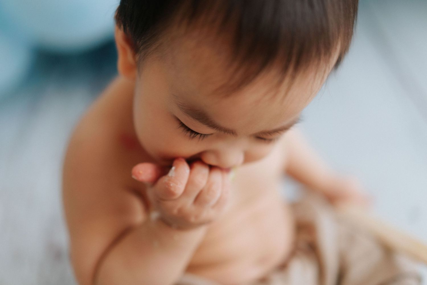 A series of photos showing a baby's different facial expressions and reactions while being fed.