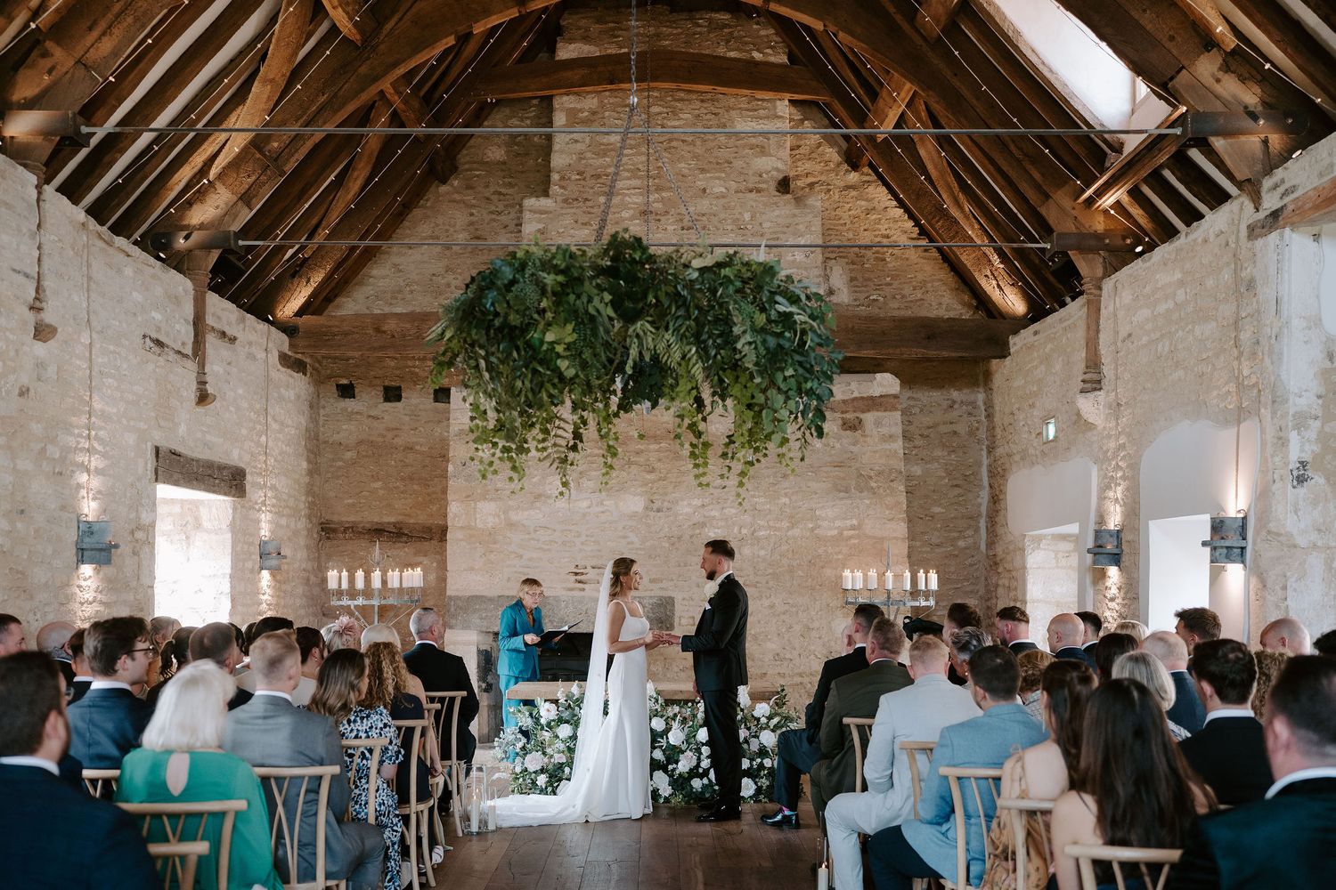 bride and groom exchanging vows during wedding ceremony at ivy lodge in cirencester