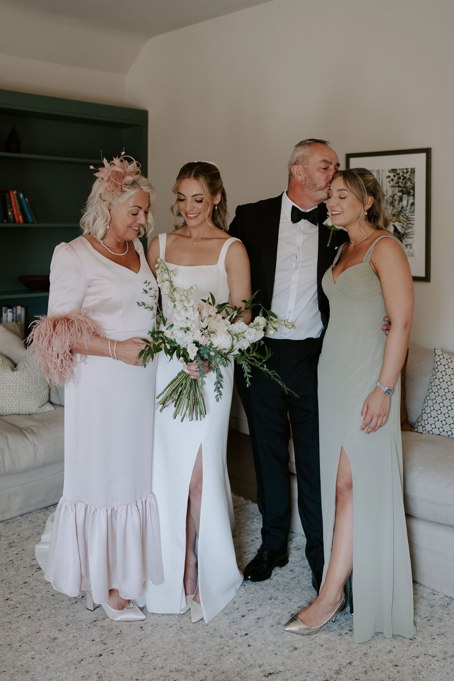 bride, mum, dad and sister sharing a special moment at ivy lodge in cirencester