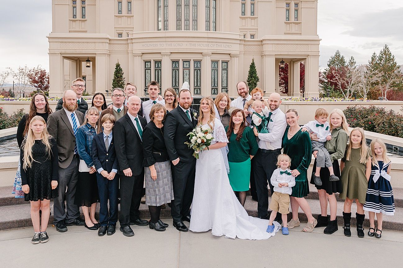 Wedding party guests gather together in multiple group photos outside an elegant stone building on a sunny day.