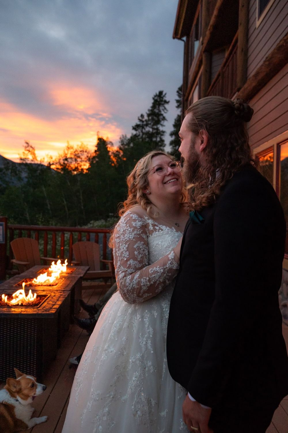 A sunset wedding celebration with warm orange skies and mountain scenery.