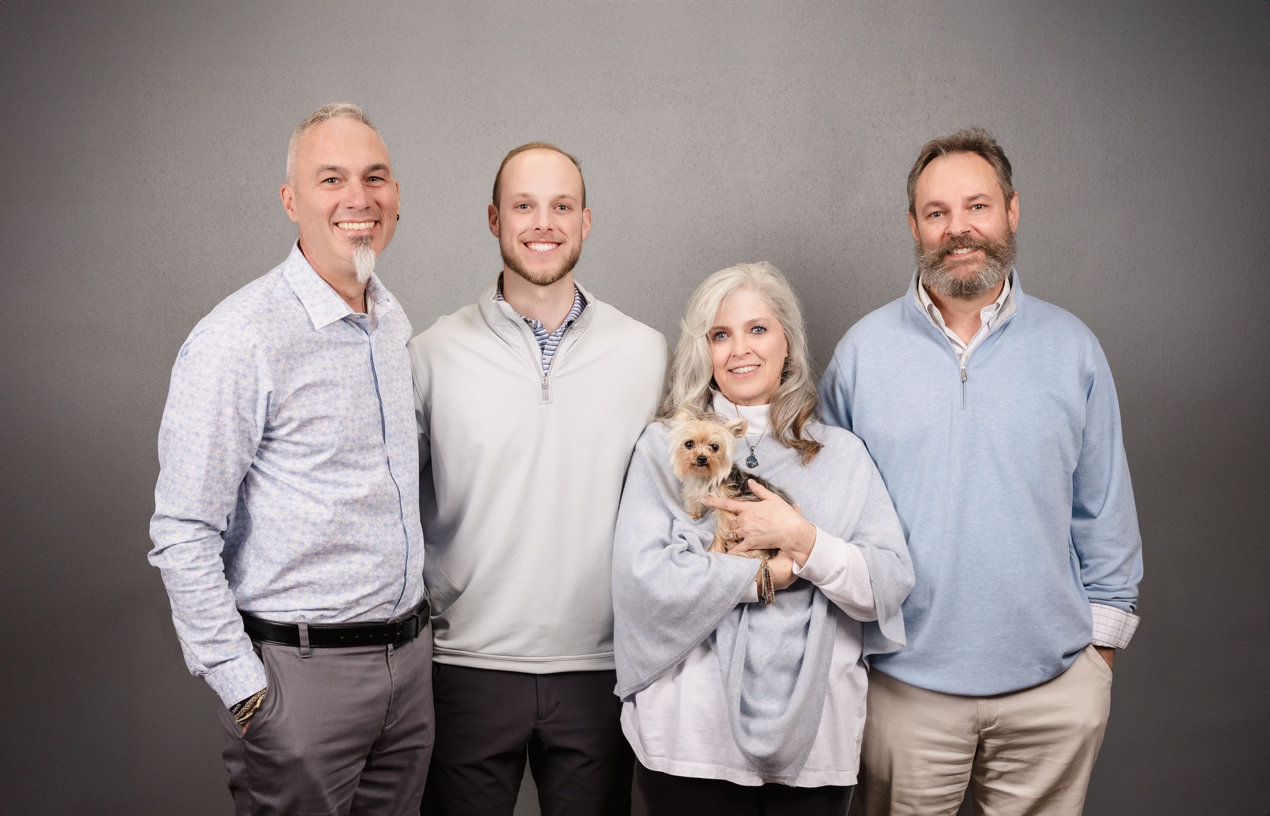 Professional group photo of business team against grey studio background.