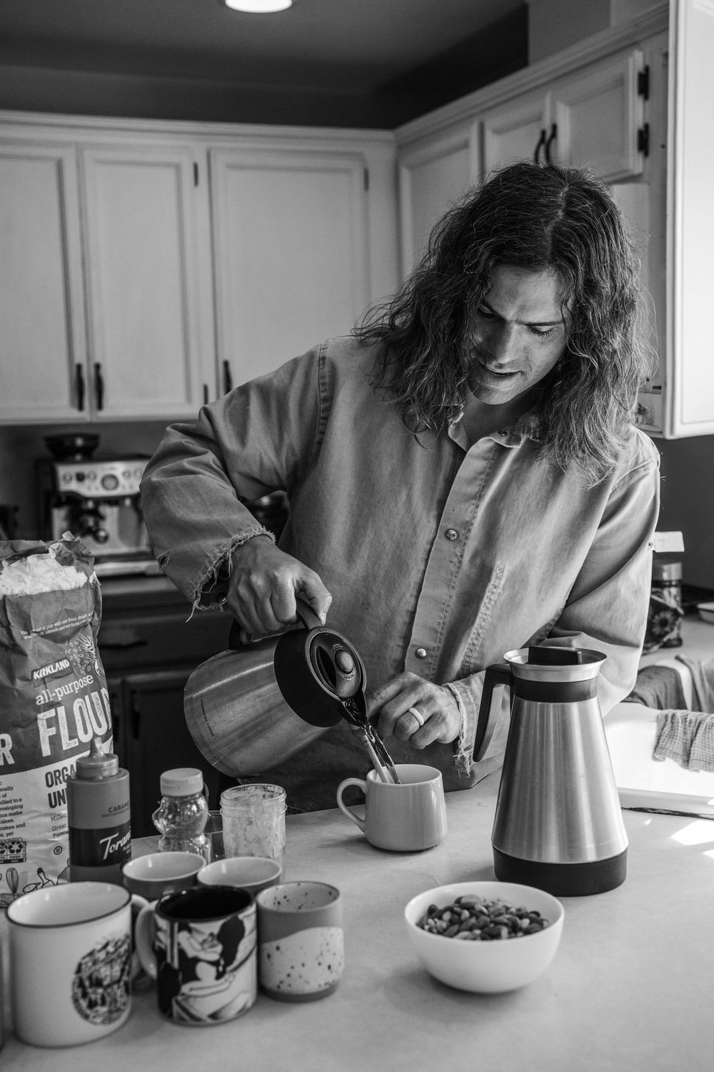 A sequence of black and white photos showing someone preparing coffee and breakfast at a kitchen counter.