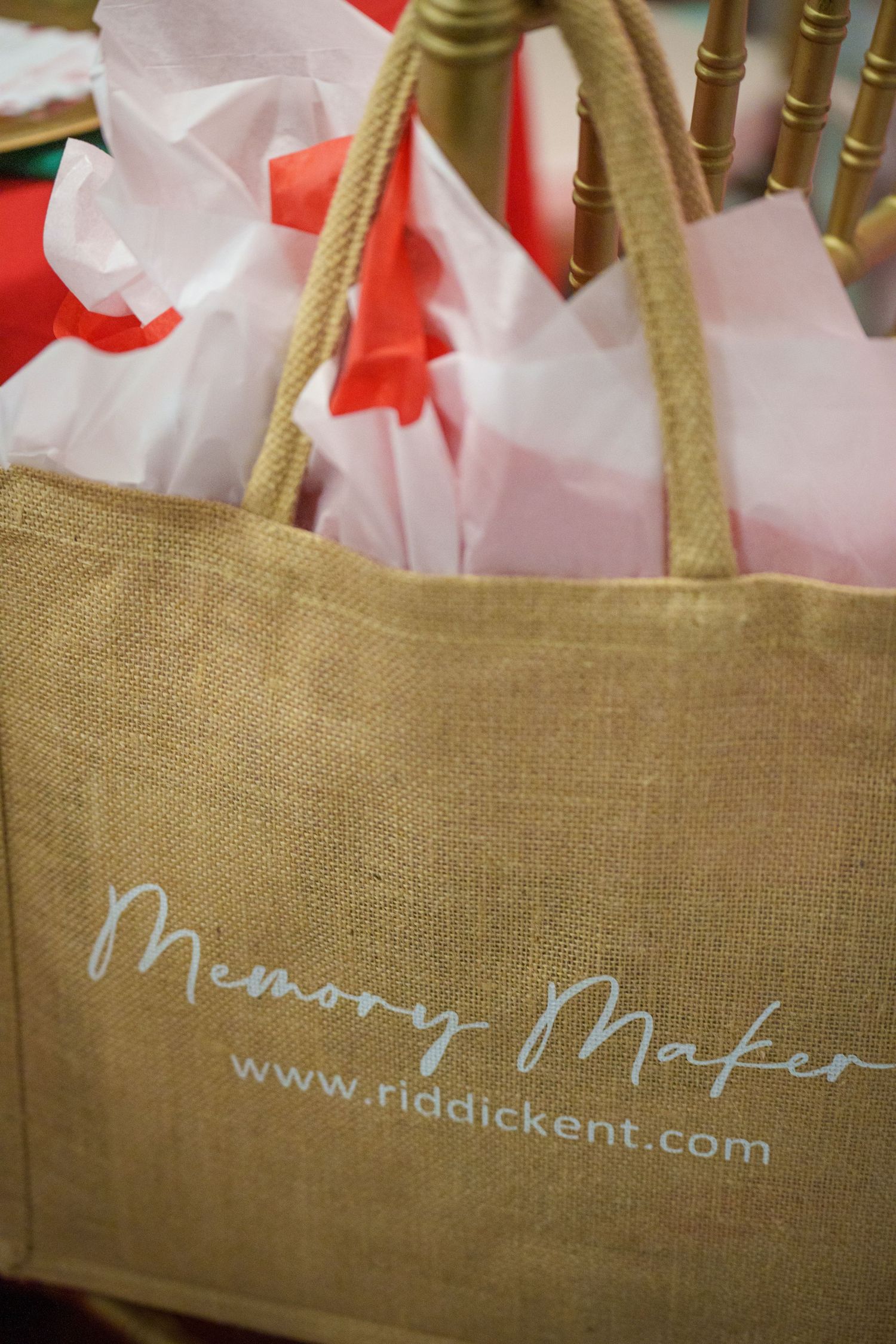 Natural burlap tote bags with white text branding displayed in a row.