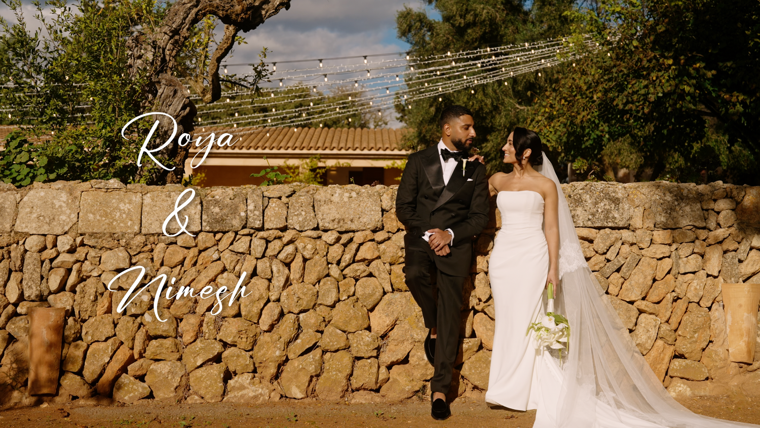 a wedding couple leaning on a stone wall at the wedding venue Son Sampol in Mallorca. Shot by Timeless weddings Mallorca videographer