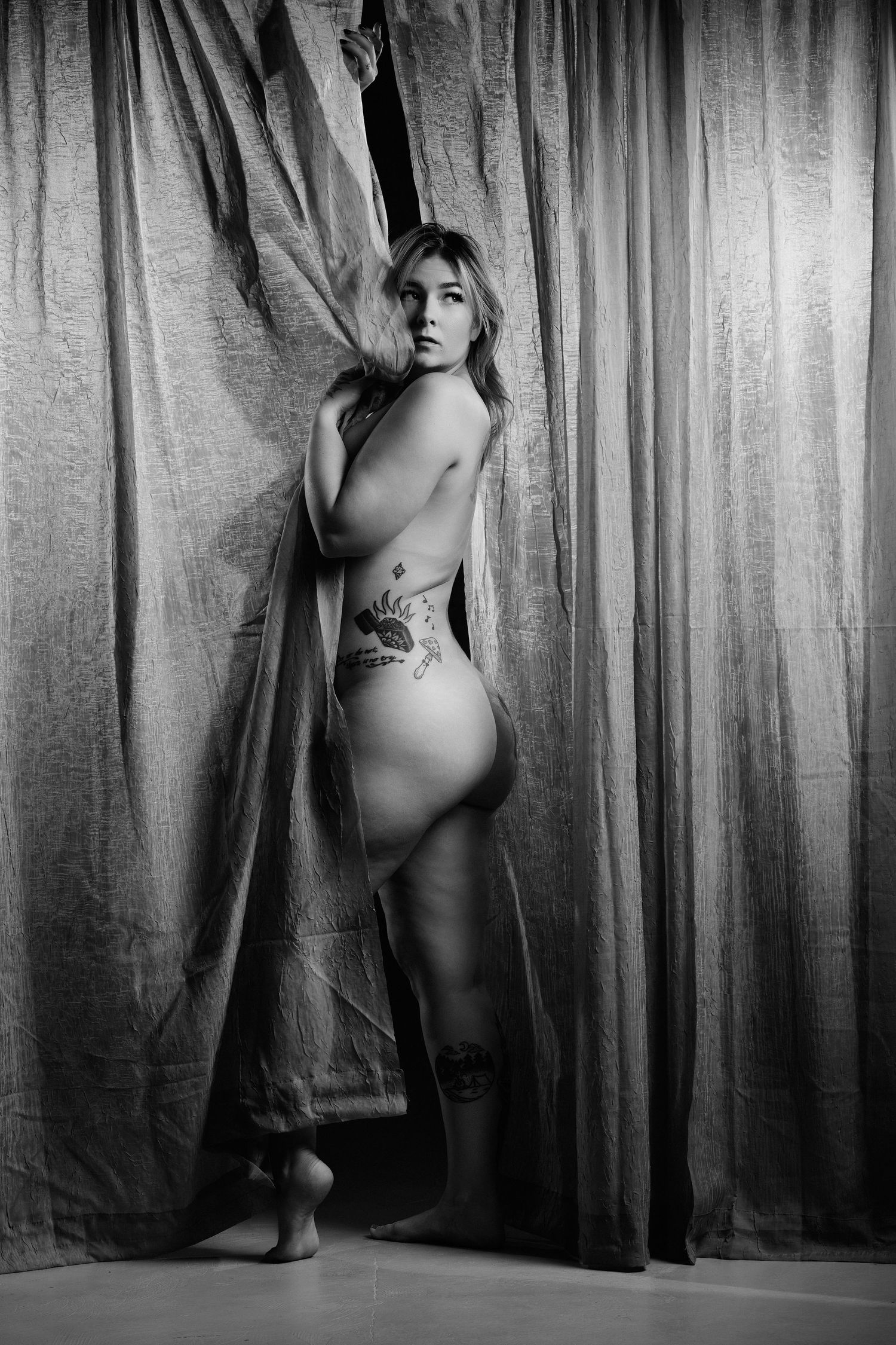 David G Holt Photography - Artistic figure study with draped fabric creating elegant silhouettes in black and white.