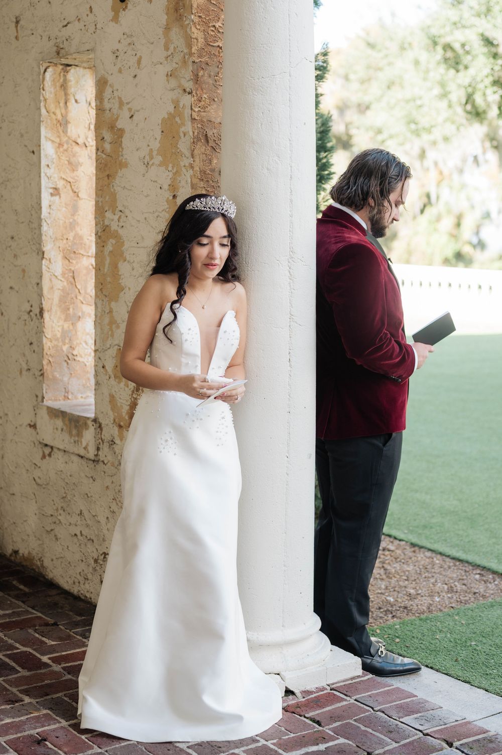 Wedding first look sequence showing a bride in a white gown waiting behind columns while partner approaches.