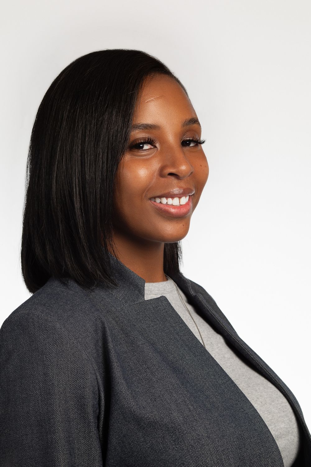 Professional headshot of a woman in a gray jacket in NYC