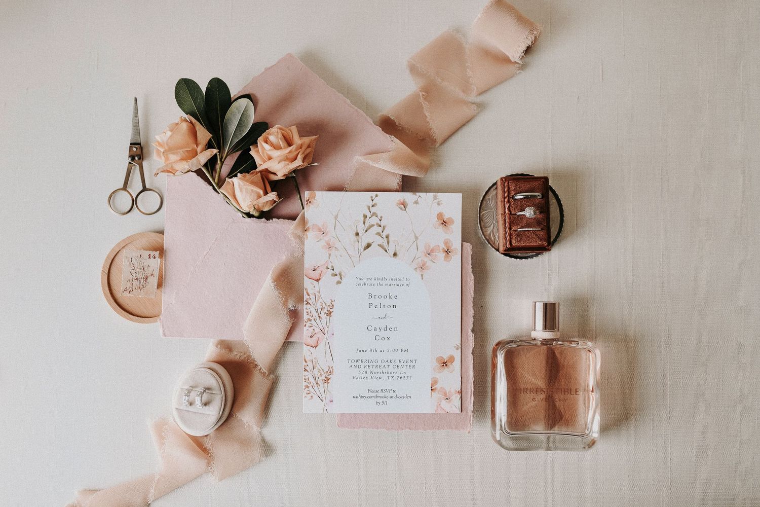 Spring wedding reception details featuring soft pink tones and organic greenery.